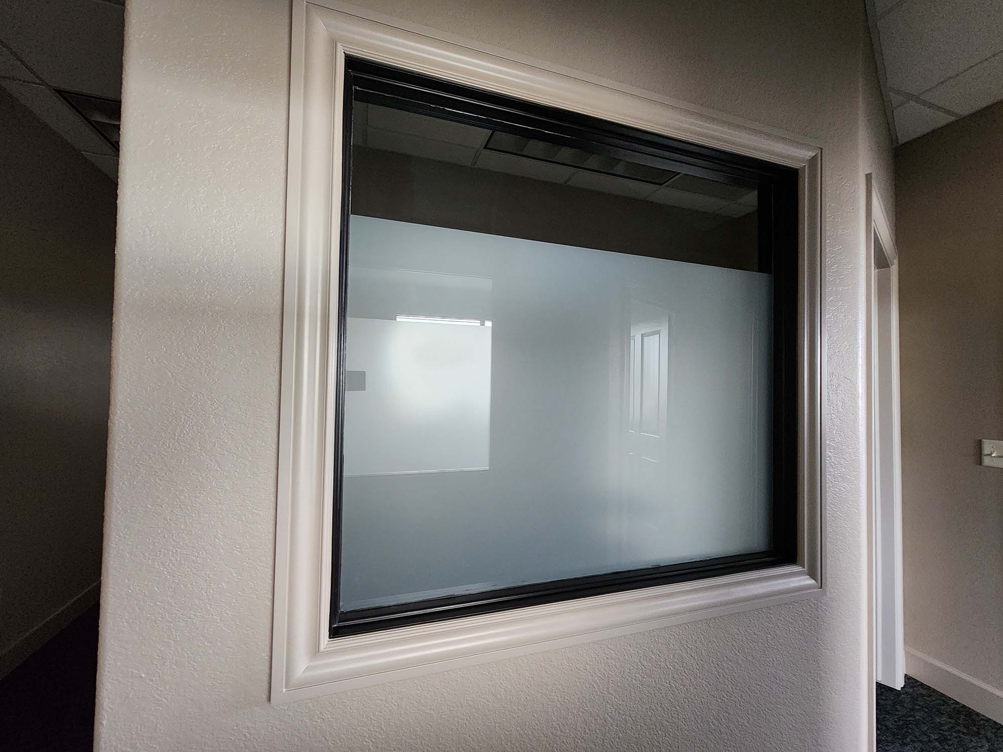 Custom frosted privacy window film installed on interior office glass